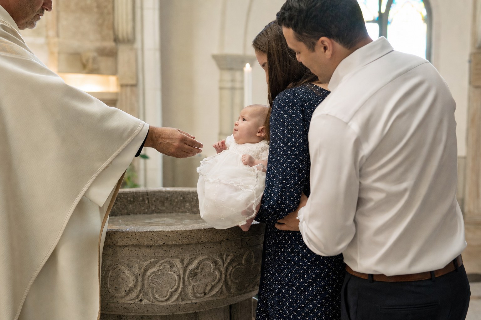 Family gathered near a baptismal font